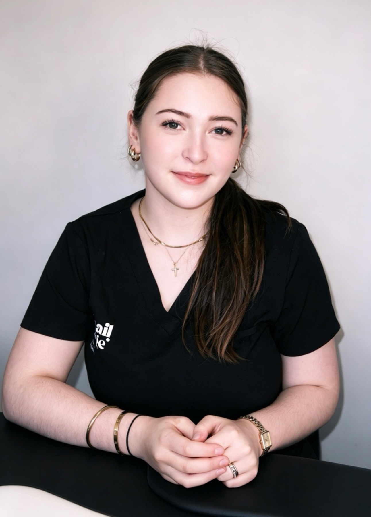 Nail technician seated at her studio table