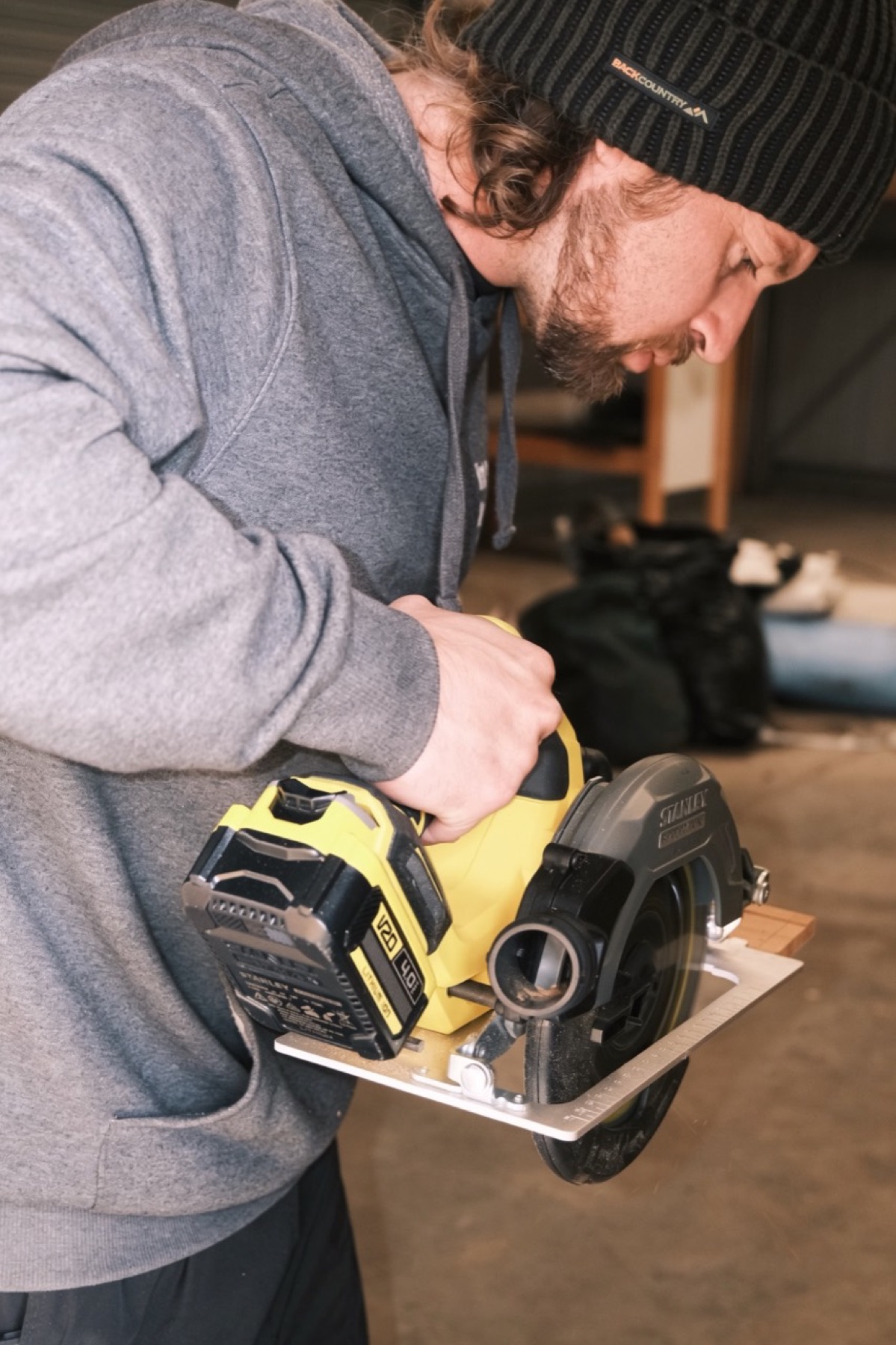 Property maintenance worker preparing a circular saw